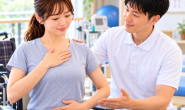 ALS患者に対して、セラピストが呼吸法や呼吸管理を指導するリハビリ場面